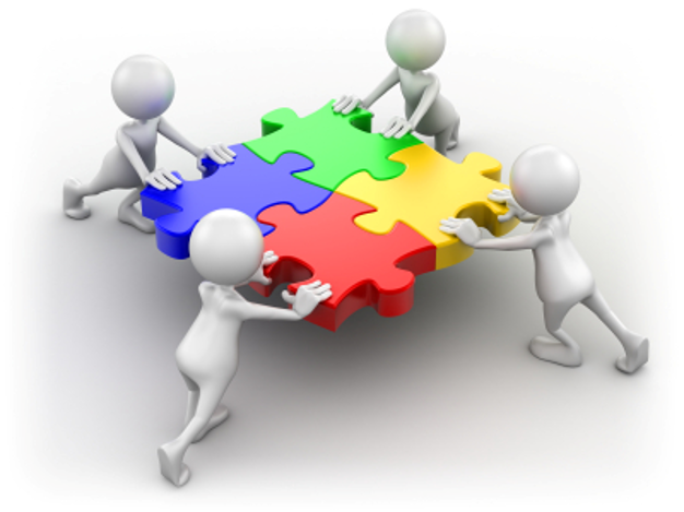 People assembling colorful puzzle pieces
